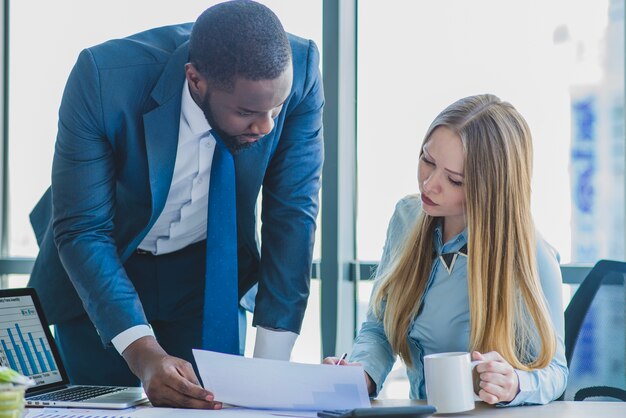 Zakenman en zakenvrouw controleren van een document