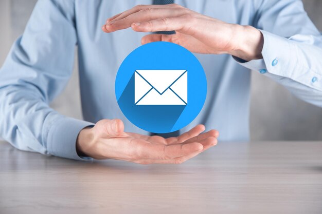 Zakenman hand met letterpictogram, e-mail iconen. neem contact met ons op via nieuwsbrief e-mail en bescherm uw persoonlijke gegevens tegen spam mail. klantenservice callcenter contact met ons op. e-mail marketing nieuwsbrief.