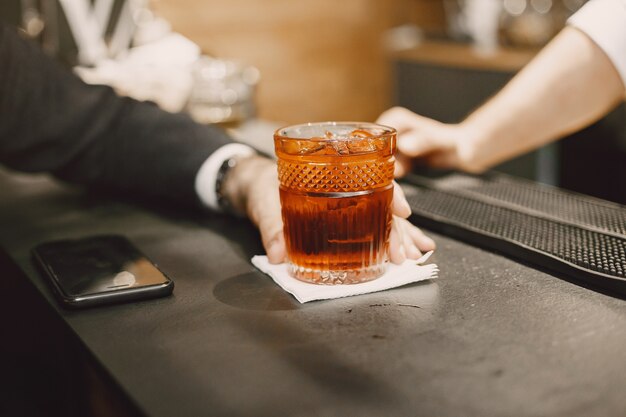 Zakenman in een pub met cocktail