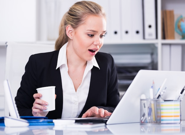 Zakenvrouw in de verrassing kijken naar de monitor