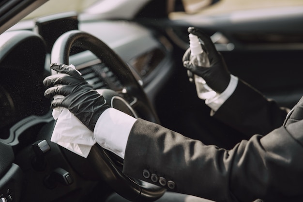 Zakenvrouw in een zwart masker zitten in een auto