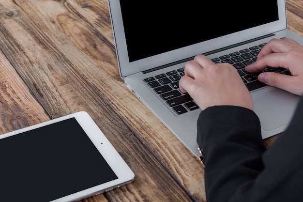 Zakenvrouw werken met de laptop naast een tablet