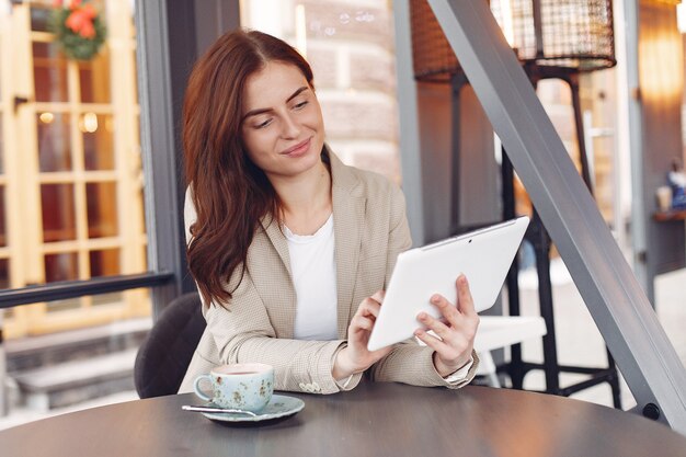 Zakenvrouw zitten aan de tafel met een tablet