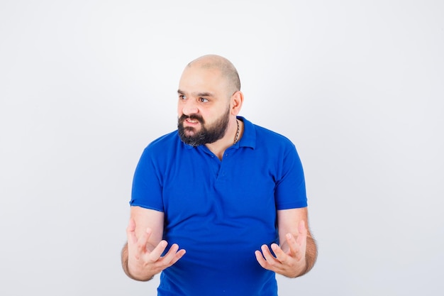 Zelfverzekerde jongeman in blauw t-shirt