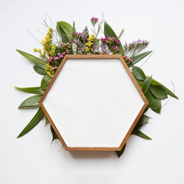 Zeshoekig frame op bladeren en bloemen