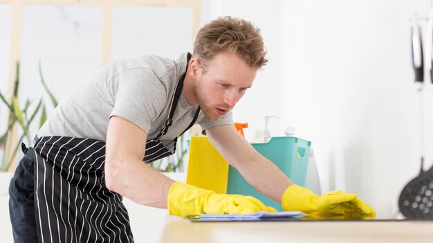 Zijaanzicht man schoonmaak keuken