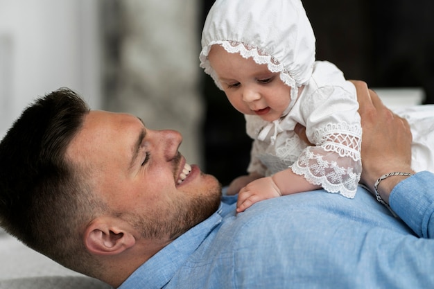 Gratis foto zijaanzicht smiley vader met baby