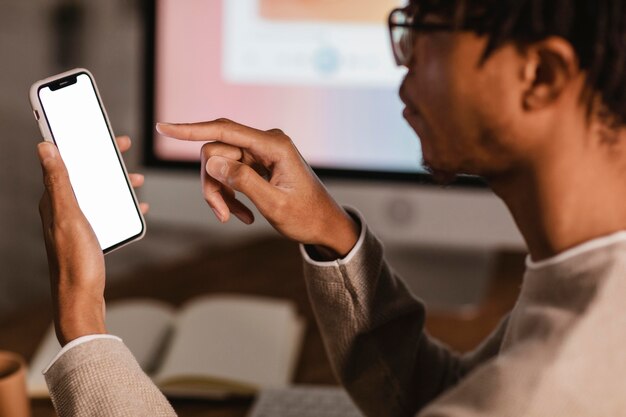 Zijaanzicht van de mens met behulp van moderne smartphone