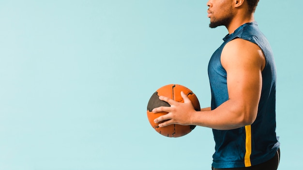 Zijaanzicht van het basketbal van de atletenholding met exemplaarruimte