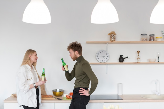 Zijaanzichtman en vrouw die van bier samen genieten