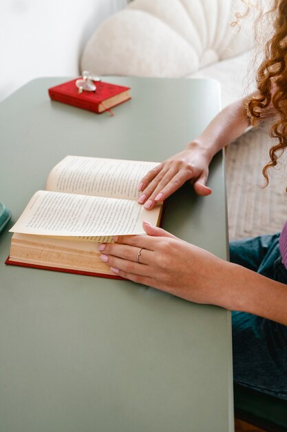 Zijaanzichtvrouw die thuis leest