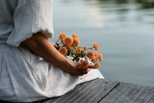 Zijaanzichtvrouw met mooie bloemen