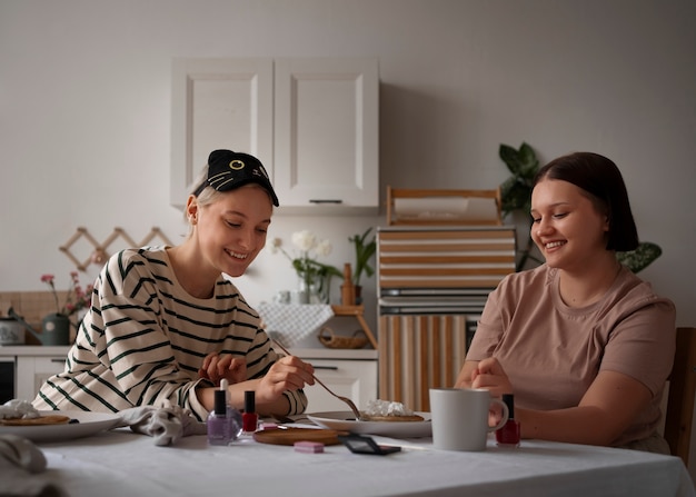 Gratis foto zijaanzichtvrouwen die manicure krijgen