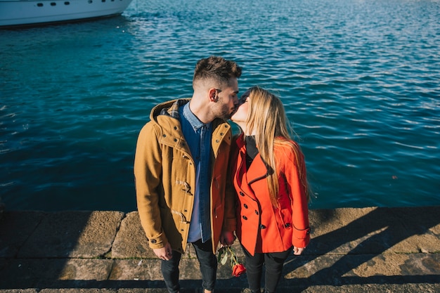 Gratis foto zoenende mensen in zonlicht aan de kust