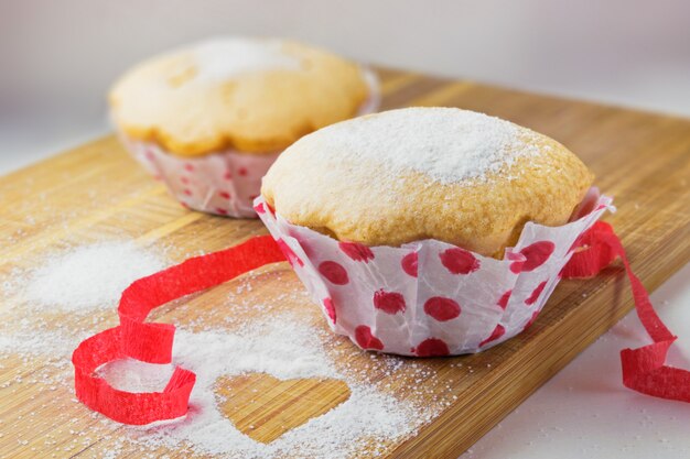 Zoete muffin met suiker en rood lint decoratie