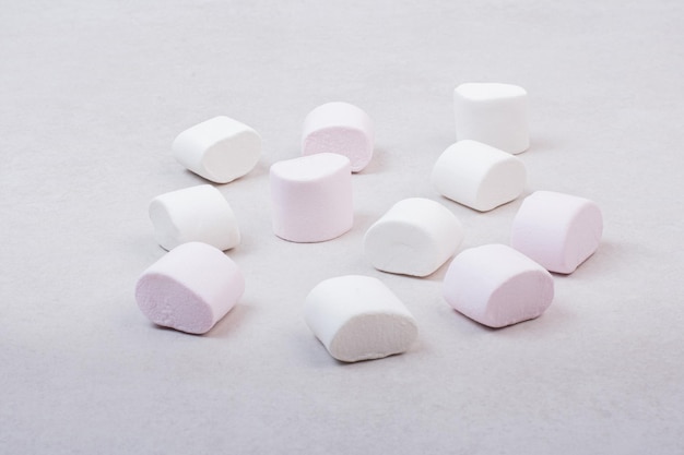 Zoete witte marshmallows op witte tafel.