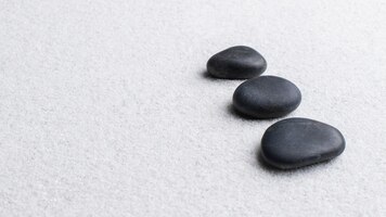 Zwarte zen stenen gestapeld op een witte achtergrond in wellness concept