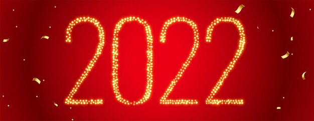 2022 tekst geschreven in gouden glitters op rode confetti banner