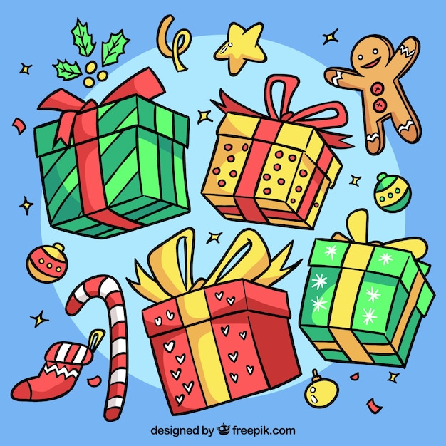 Gratis vector assortiment handgetekende kerstcadeaus