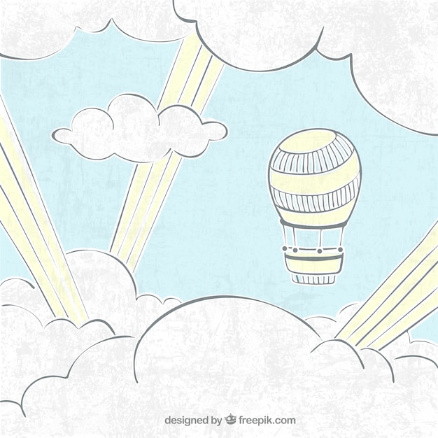 Gratis vector ballon tussen handgetekende wolken achtergrond