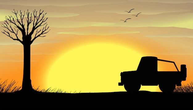 De zonsondergangscène van het silhouet met een vrachtwagen