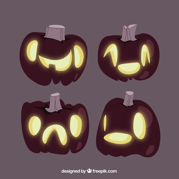 Gratis vector donkere verlichte halloween pompoenen