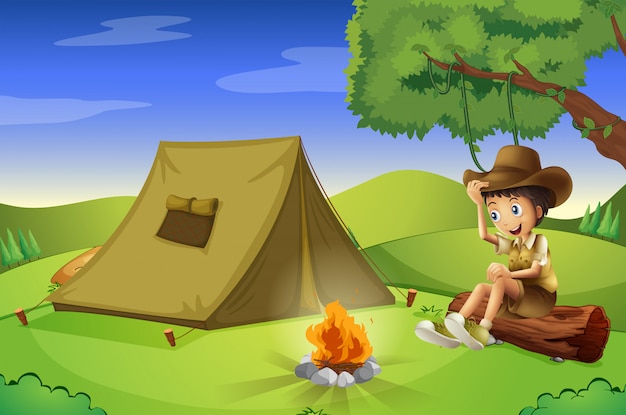 Een jongen met een tent en een kampvuur