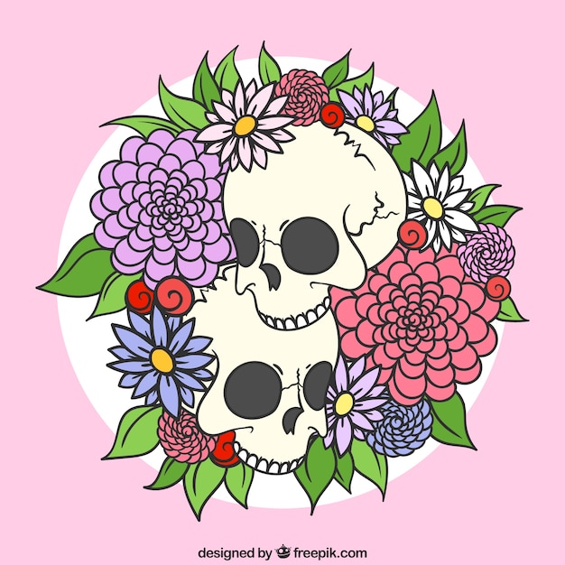 Gratis vector hand getrokken schedels met decoratieve bloemen