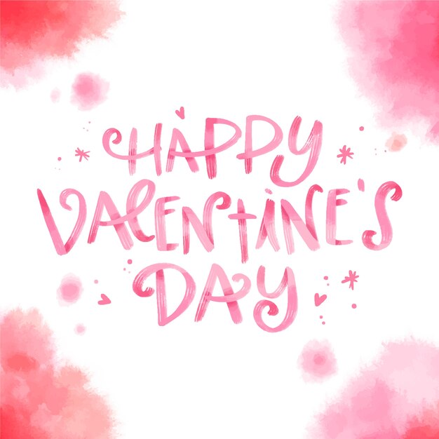 Gratis vector happy valentijnsdag belettering met aquarel vlekken