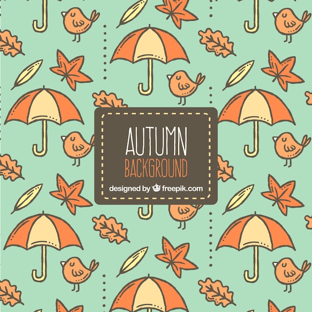 Gratis vector herfst achtergrond met hand getekend patroon