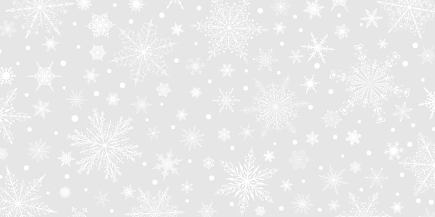 Kerstachtergrond van verschillende complexe grote en kleine sneeuwvlokken, wit op grijs