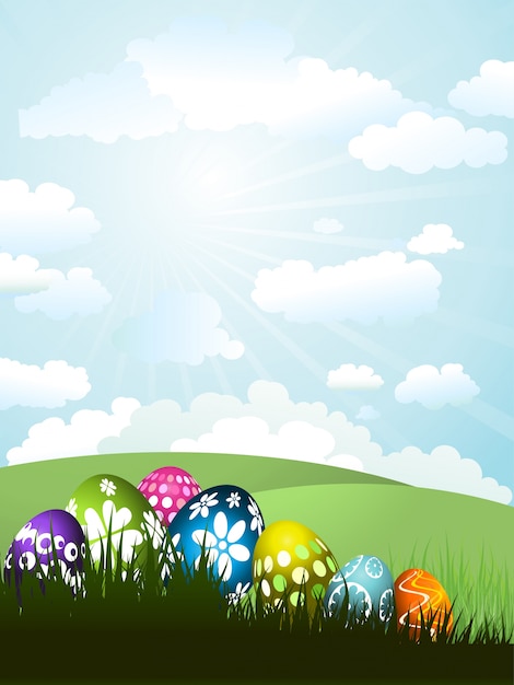 Gratis vector kleurrijke paaseieren in het gras op een zonnige landschap achtergrond