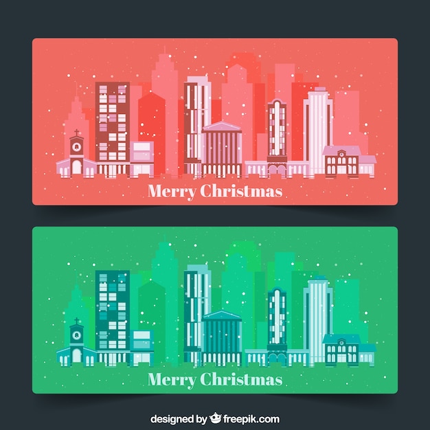 Gratis vector merry christmas banners met gebouwen en sneeuw