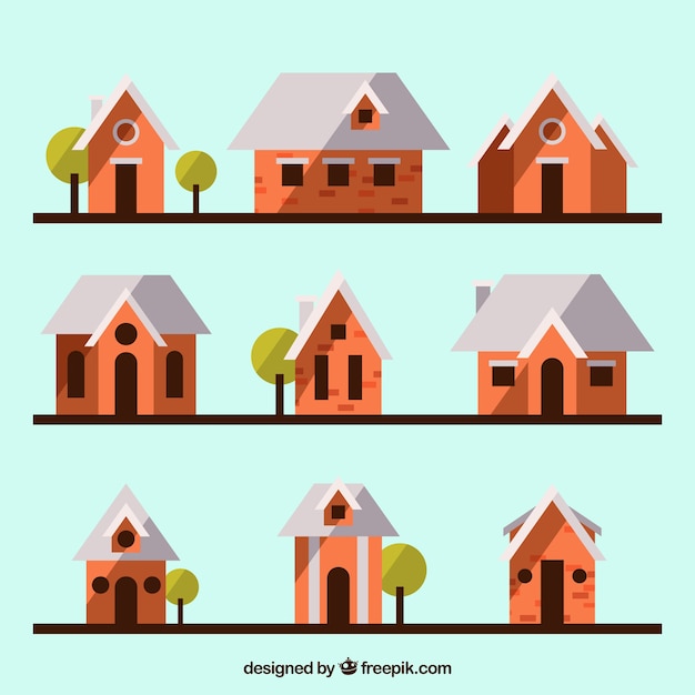 Gratis vector mooie huizen met bomen in plat ontwerp