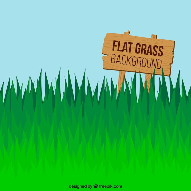 Gratis vector platte groene gras achtergrond met teken