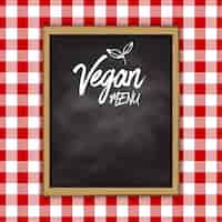 Gratis vector veganistisch menu schoolbord ontwerp op een gingangdoek achtergrond
