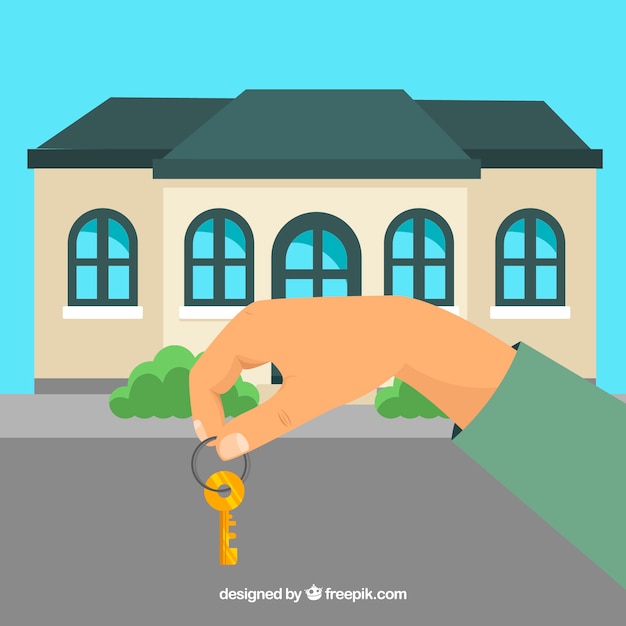 Gratis vector vlakke hand met huis sleutel achtergrond