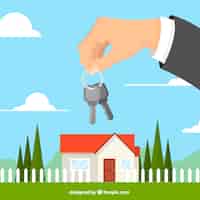 Gratis vector vlakke hand met huis sleutel achtergrond