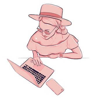 Vrouw die op laptop met smartphone in hoed en kleding werkt