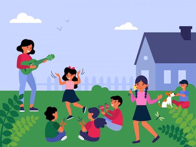 Vrouwelijke leraar gitaar spelen aan kinderen buiten spelen
